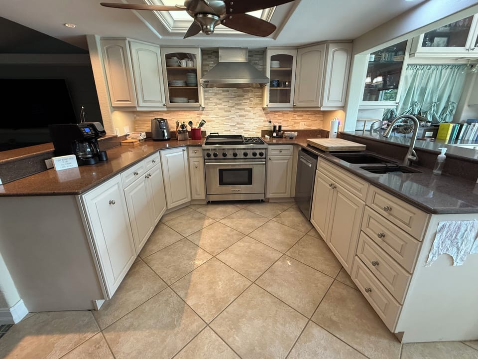 Wolf gas range/oven, dishwasher, dishes, and all necessary cooking needs. 