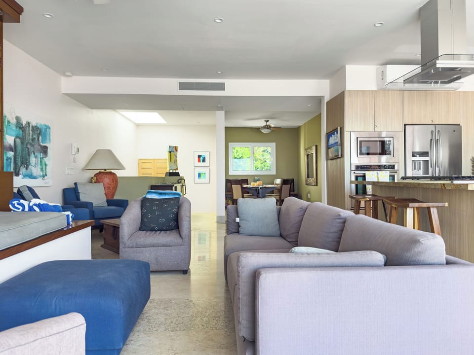 Seating area, dining table for six, stools at center island.