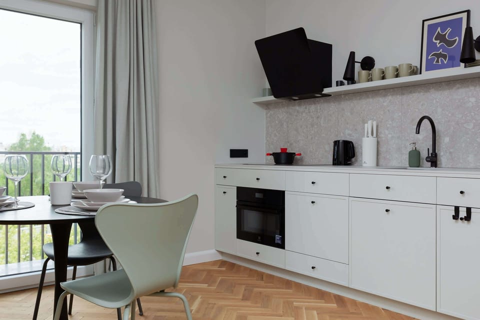 A wider perspective of the open-plan kitchen and dining area, emphasizing natural light and spaciousness.
