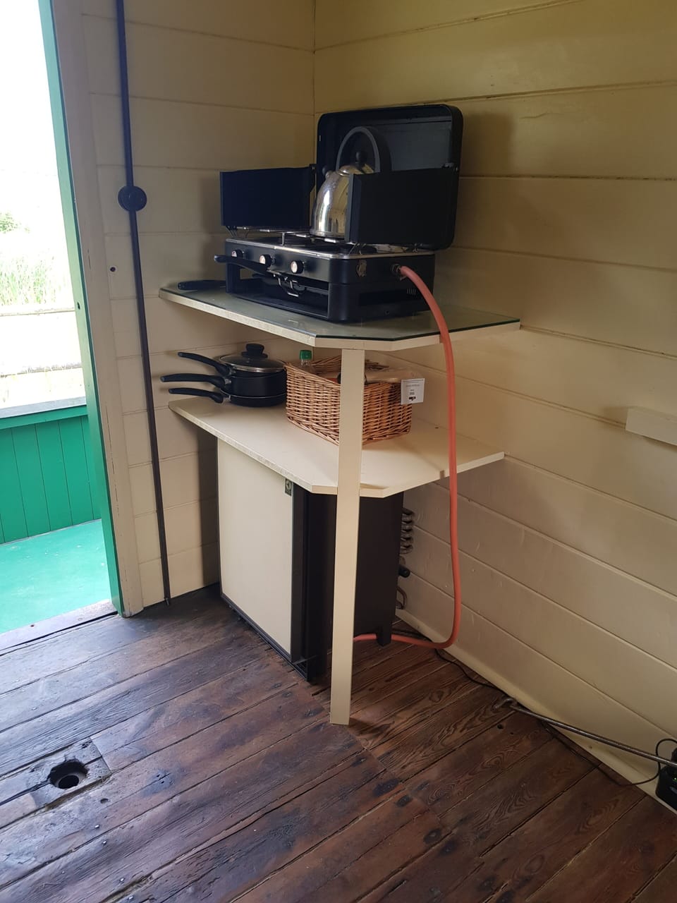 For indoor cooking a simple camping stove with mini fridge underneath. 
