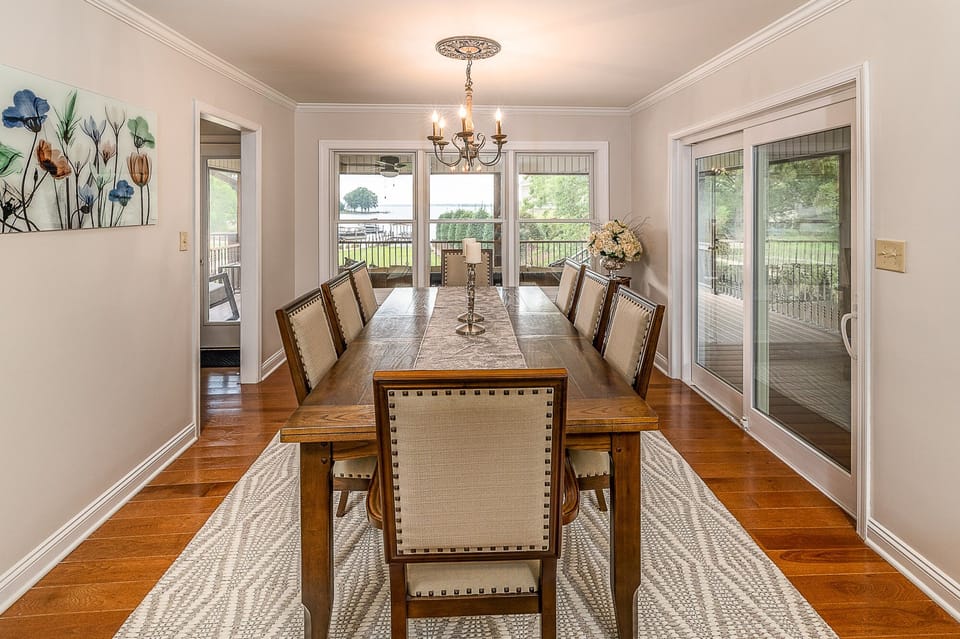 Large dining table with lake view.