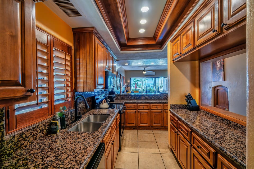 Granite line kitchen has plenty of countertop and storage