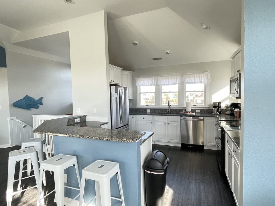 Kitchen - newer refrigerator, dishwasher, and stove. Multiple coffee pots and a Keurig.