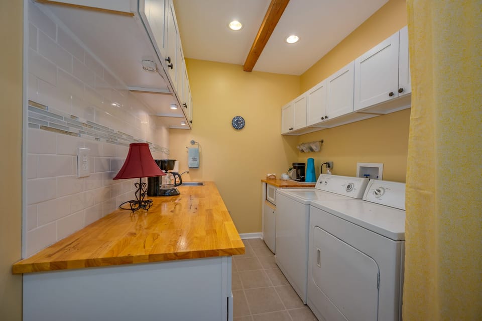 Laundry room area located in lower level of home