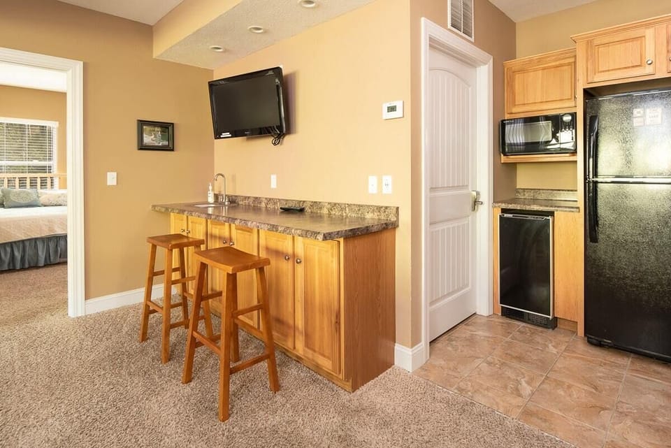 Lower-level kitchenette. 3rd refrigerator pictured