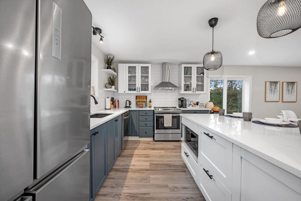 Microwave, dishwasher, oven, wine fridge and large refrigerator.