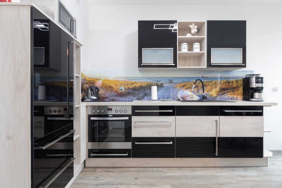 A detailed view of the kitchen, featuring a contemporary backsplash and ample storage.
