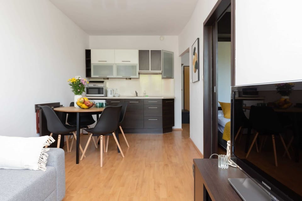 An open-plan kitchen and dining area with modern furnishings and natural light.
