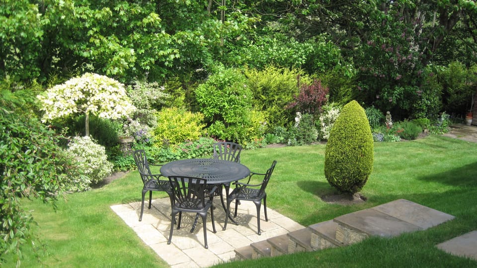 Country garden with several seating areas