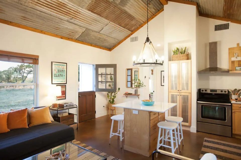 Vaulted corrugated metal ceilings add to the cottage's rustic charm