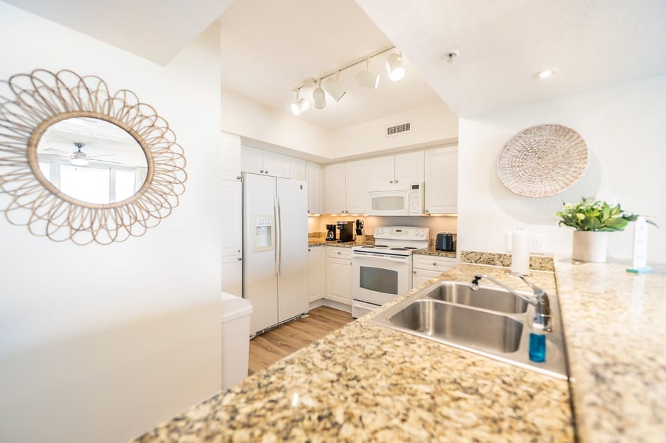 Fully-stocked kitchen including Keurig and drip coffee makers.