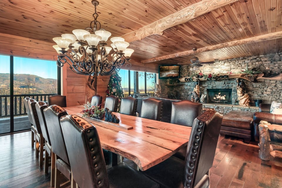 Large dining area with luxurious leather chairs and locally crafted wood table in a Pigeon Forge luxury cabin. 
