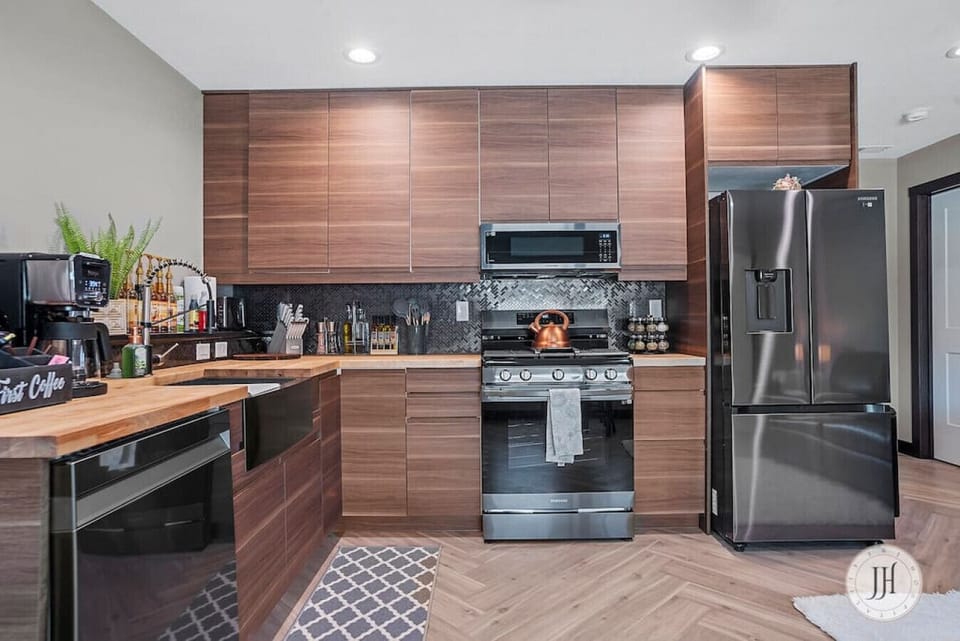 Modern, fully equipped kitchen featuring a dishwasher, stove, oven, and coffee maker—perfect for cooking and enjoying your favorite meals.