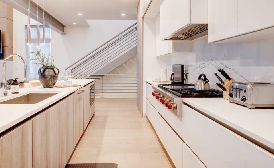 Kitchen: Chef’s dream with Wolf + Sub-Zero appliances and open layout.