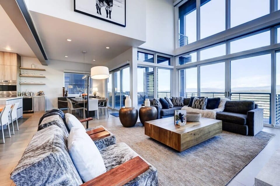 Great Room with massive windows looking out to the Uinta valley and mountains