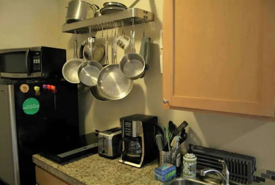 microwave, stove top induction, coffee maker, toaster, sink, dishes, pots & pans