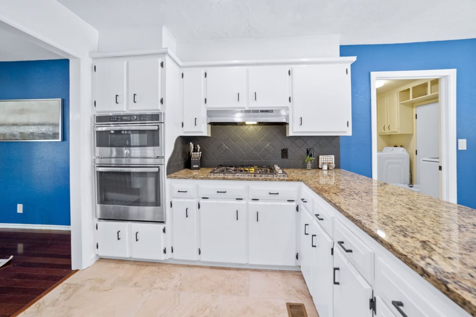 Kitchen with burners, microwave, and oven.