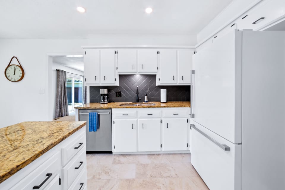 Kitchen with full size fridge and dishwasher.