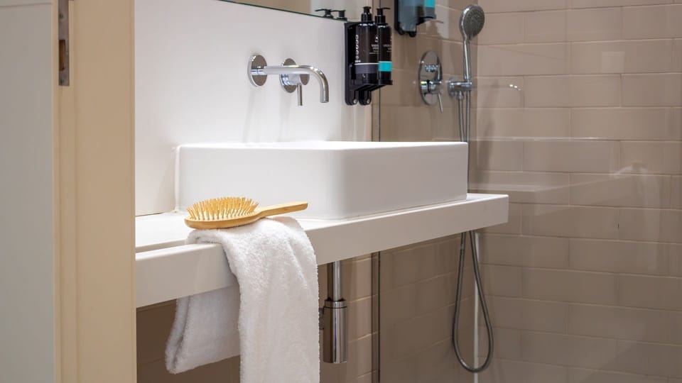 Refresh in the sleek, modern bathroom featuring a stylish basin and an invigorating shower after a day exploring the city.
#Bathroom #ModernDesign #LovelyStay