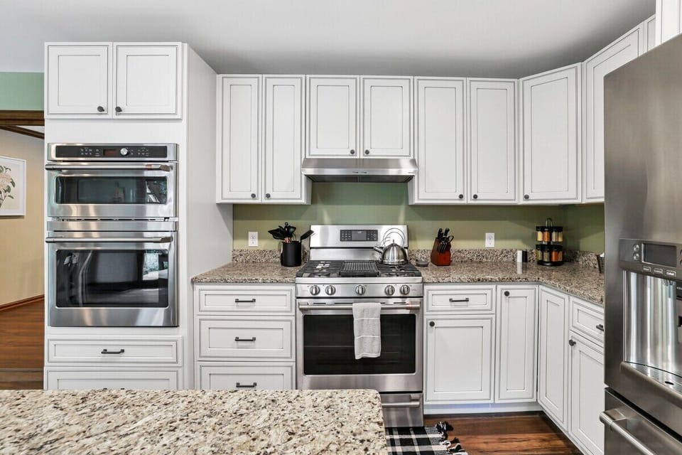 Fully stocked kitchen with Cafe wall microwave and over, gas range and stainless steel fridge