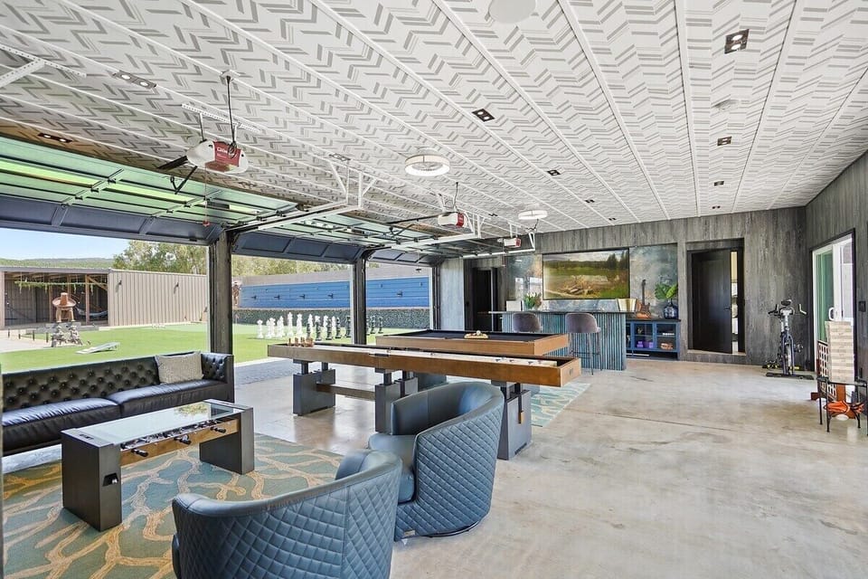 Game room- with a mini foosball table, shuffleboard, pool table, bar, and a variety of games