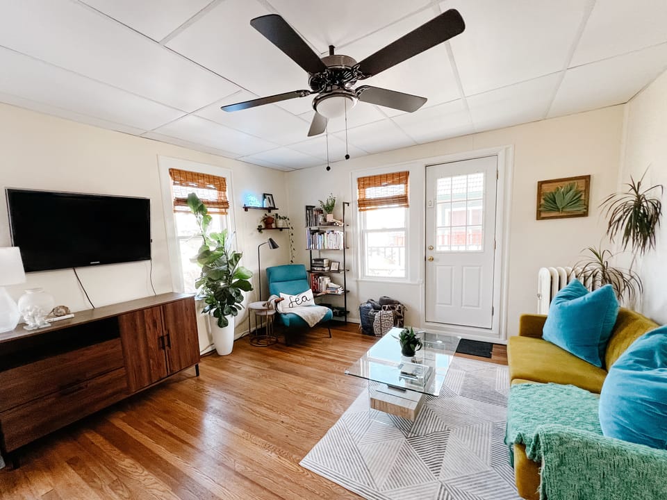 Living room with futon couch. Full sized & toddler air mattress