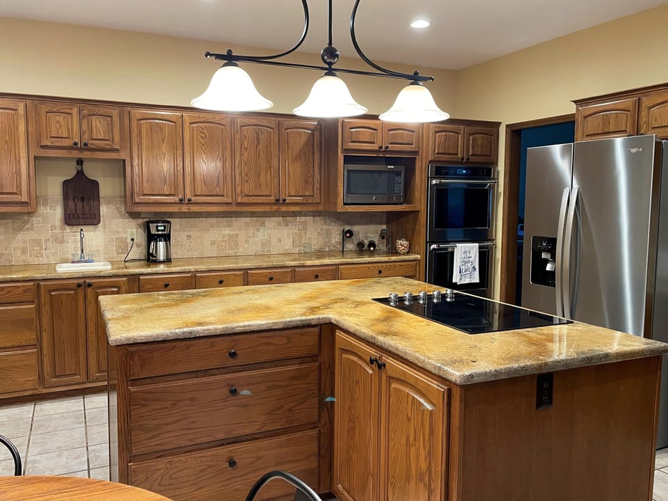 Double ovens, coffee maker, stove, large island