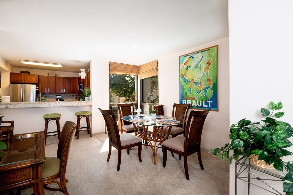 Inviting dining area where you can enjoy breakfast or dinner with gentle ocean sounds and partial sea views through palm trees.