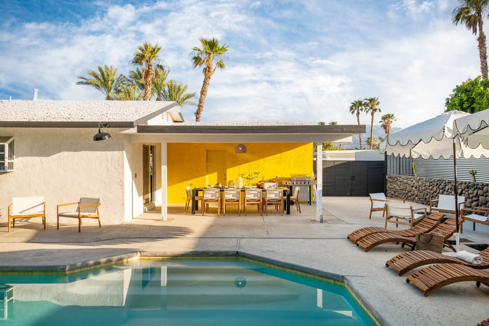 Covered outdoor dining area and loungers.