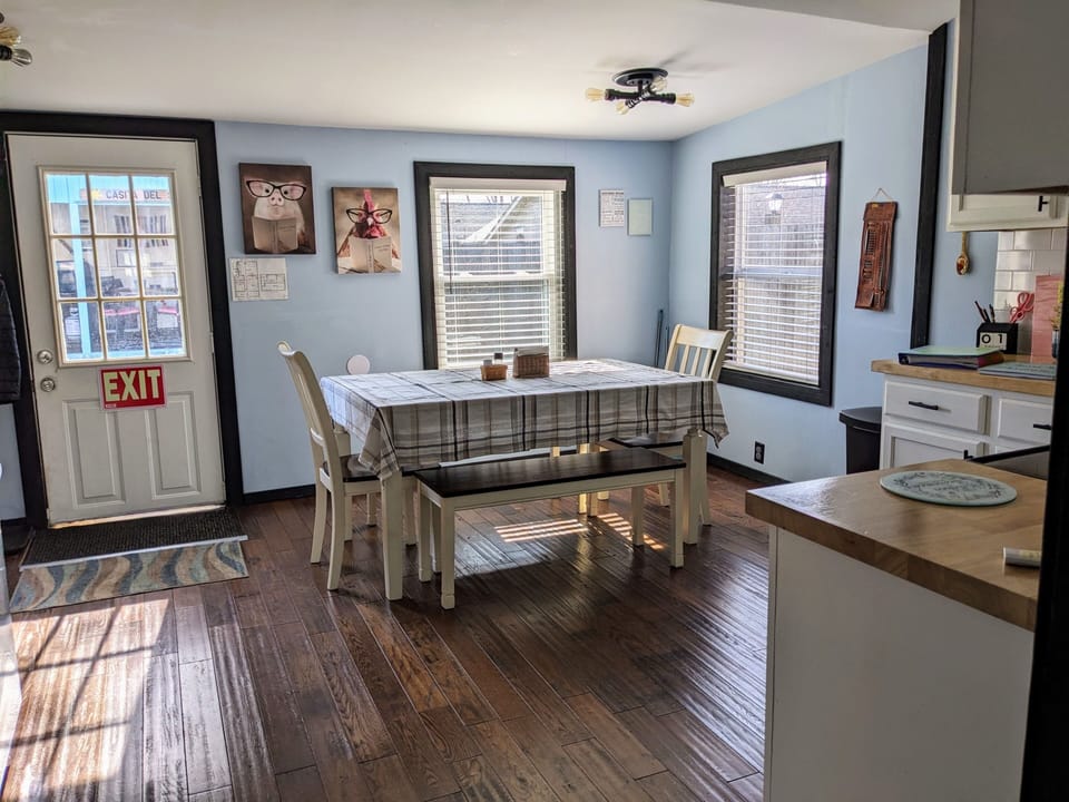 Dining for up to 8 with view of gazebo and fenced in yard.