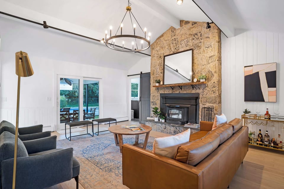 Living room with fireplace and pool views