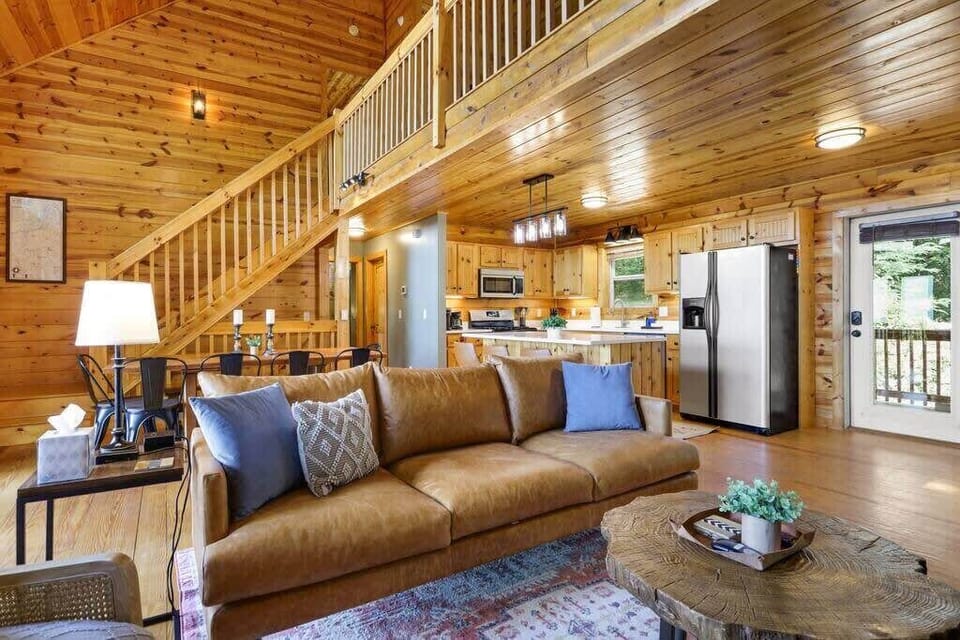 Open concept living, dining room and kitchen leading out to the large porch