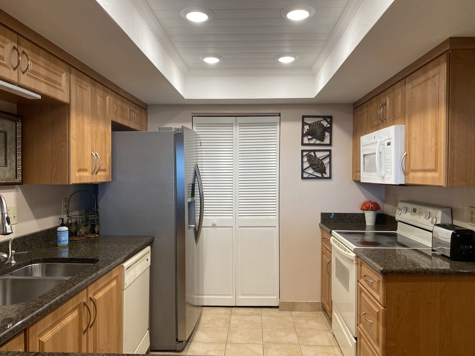 Kitchen with laundry room and full size washer and dryer.