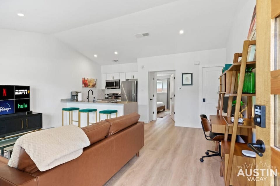 Beautiful and open living space with large island, sofa and office