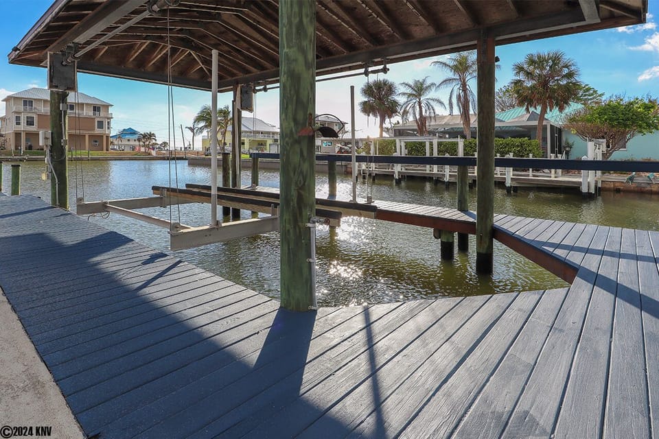 Private Boat Dock and Boat Lift sit on a wide canal that leads to the Bay