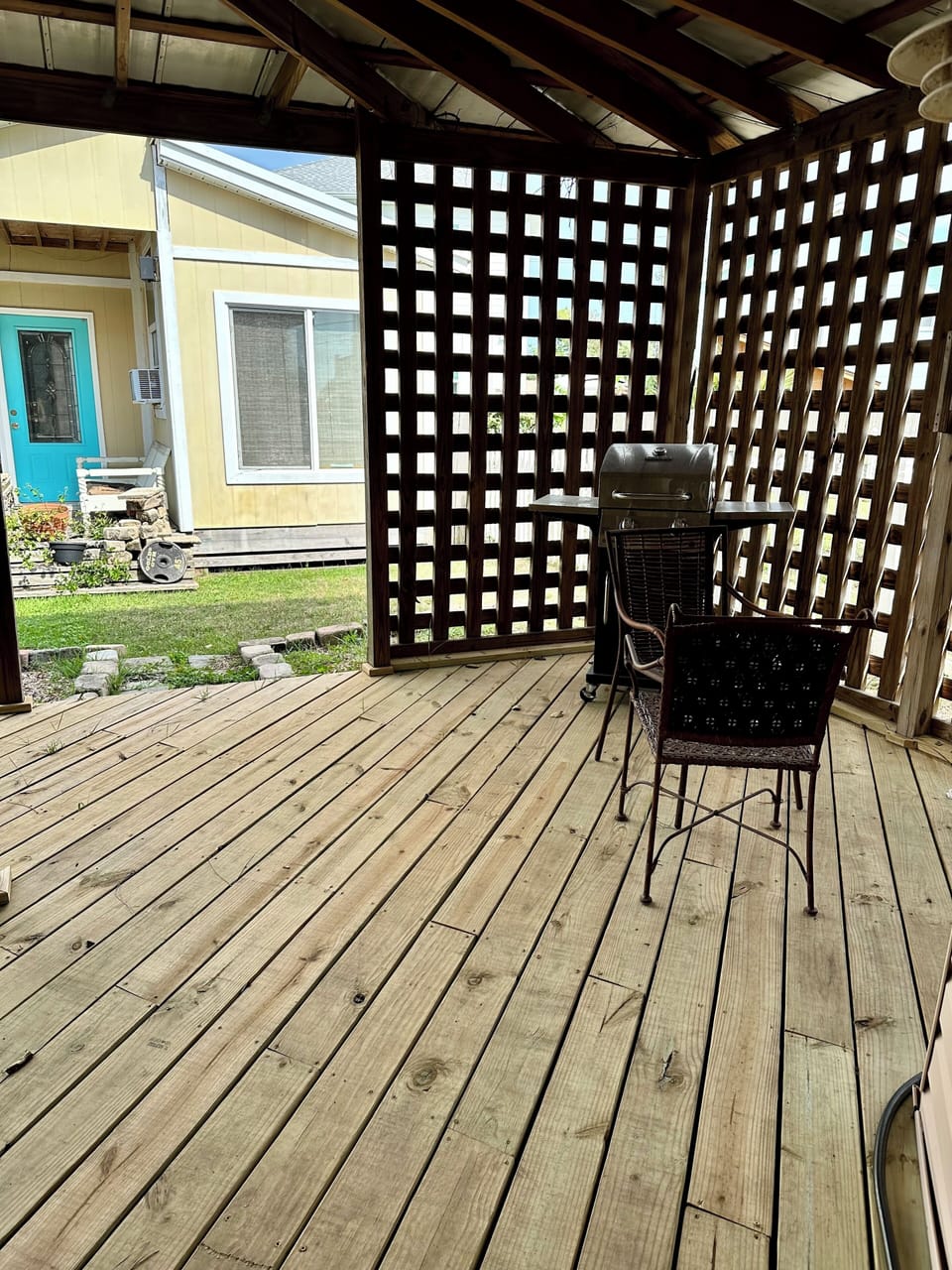 Deck in backyard with gas grill