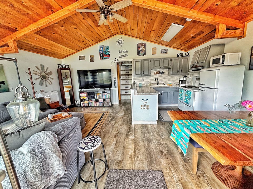 Living, dining and kitchen. That is a 70 inch smart tv. :)