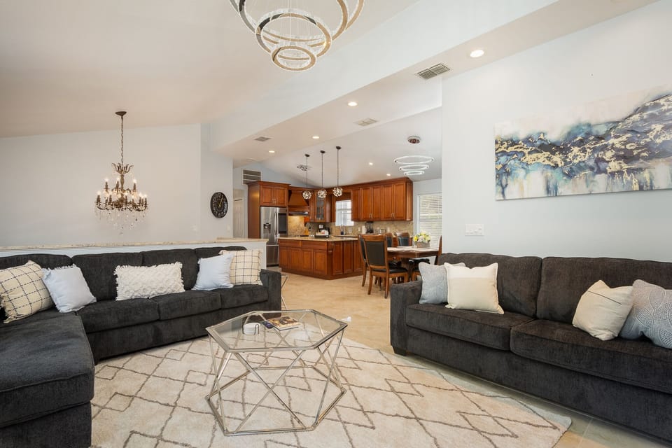 View of the living room with kitchen and dining area in the background. 