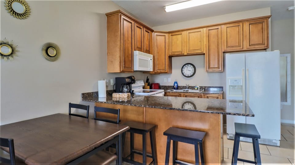 Seat the whole family for meals with a 4-person table, with 4 bar stools. 