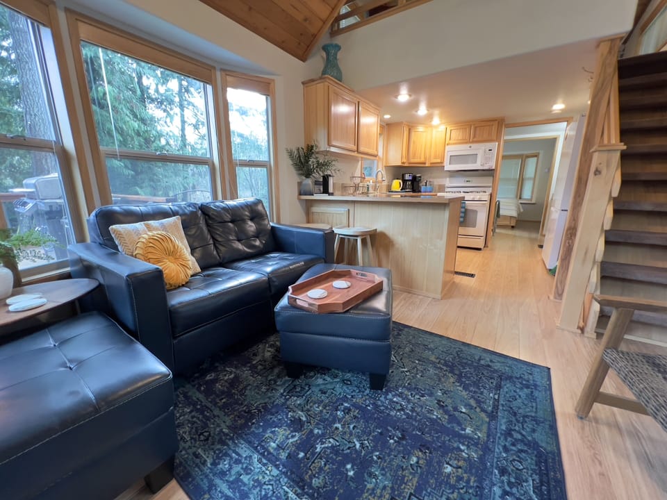 Open-concept living with forest views and direct access to the covered deck