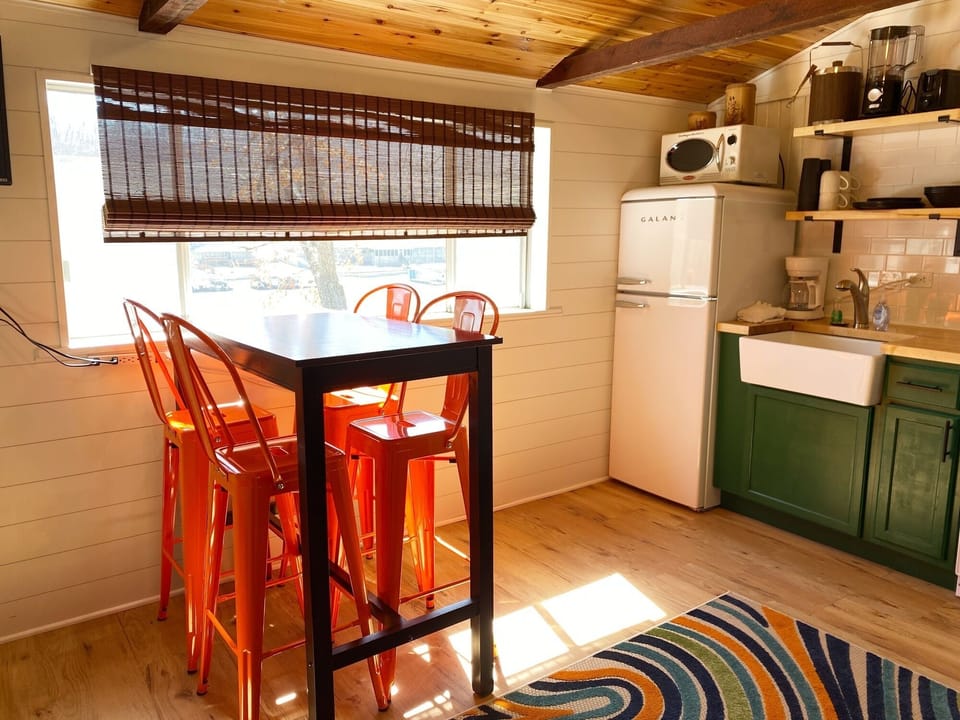 The dining table is a countertop height table that seats 4.