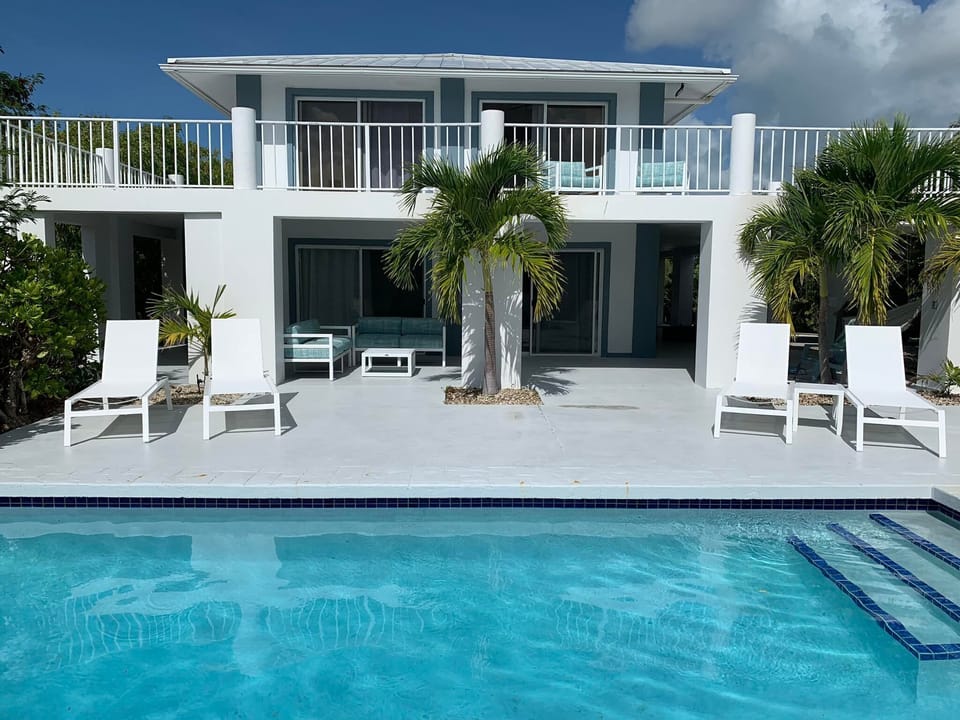 view from across the pool. New pool loungers and conversation sets.