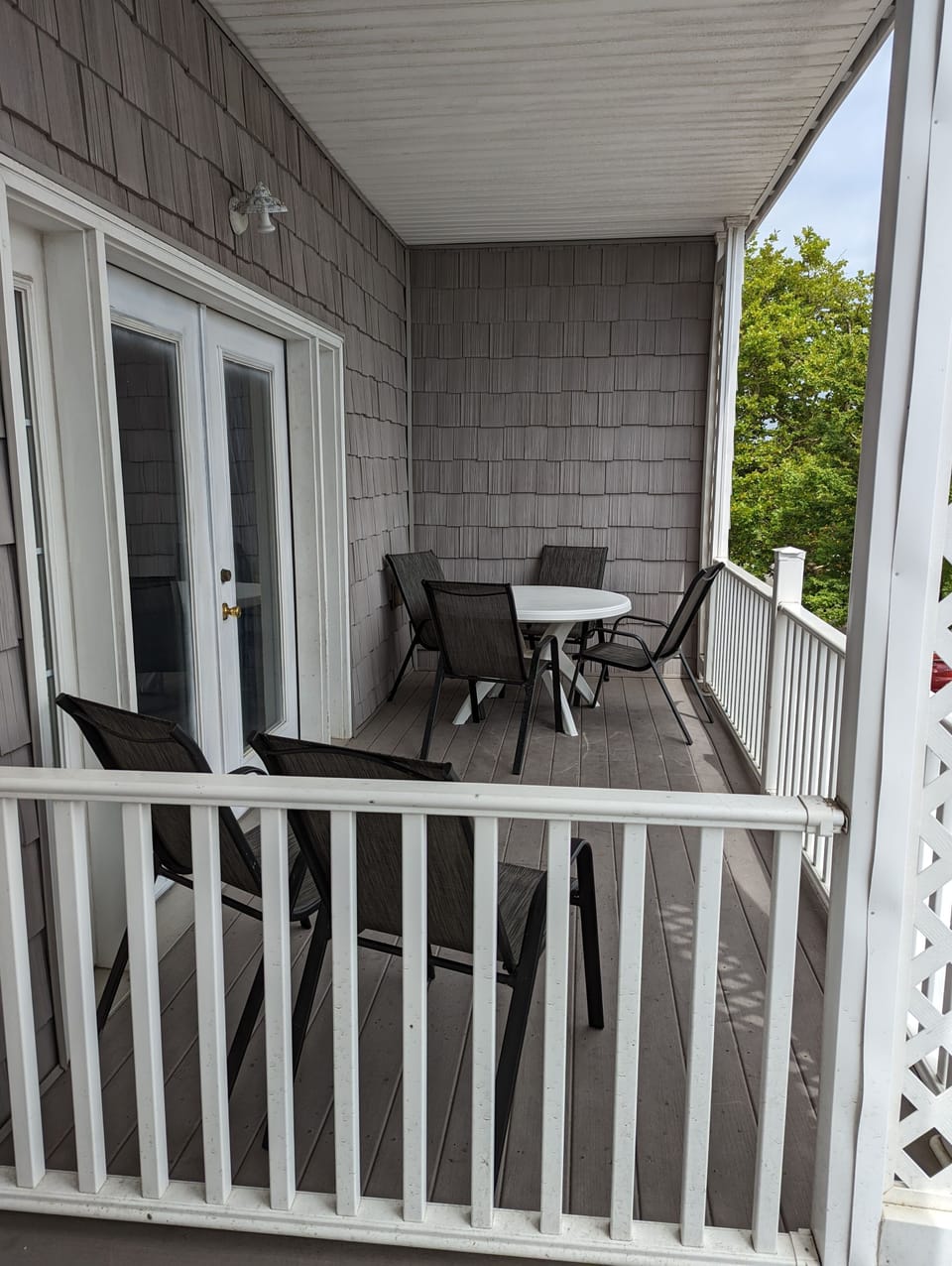Balcony seating with a table and 4 chairs and 2 side chairs.