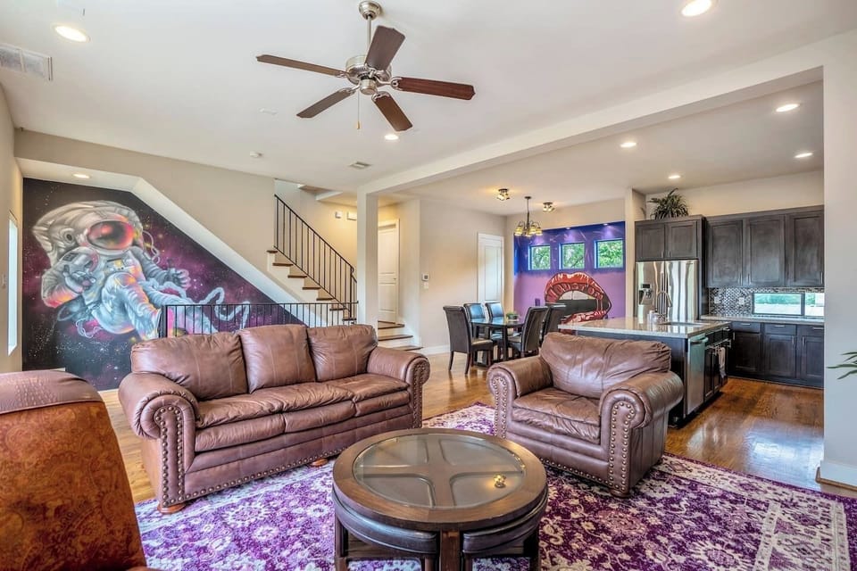 Great gathering space with murals and artwork all around in this open concept living, kitchen, dining level. 