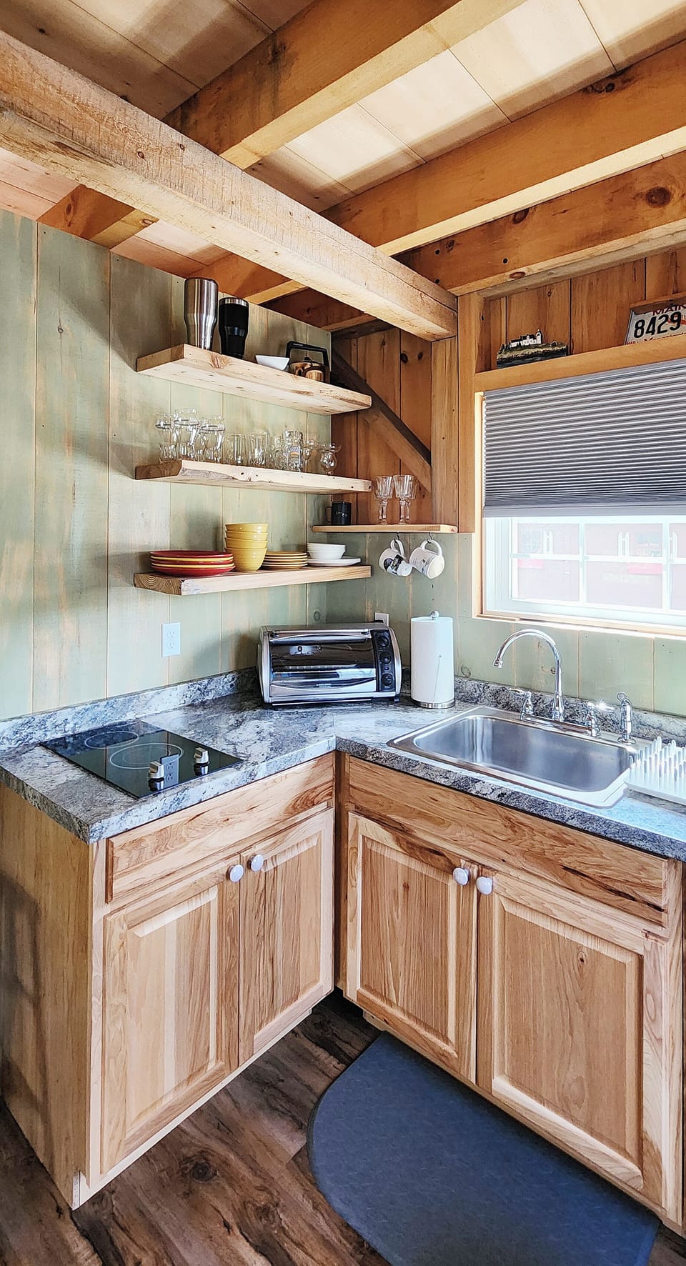 Kitchen includes a 2 burner counter top stove, toaster oven, and microwave.