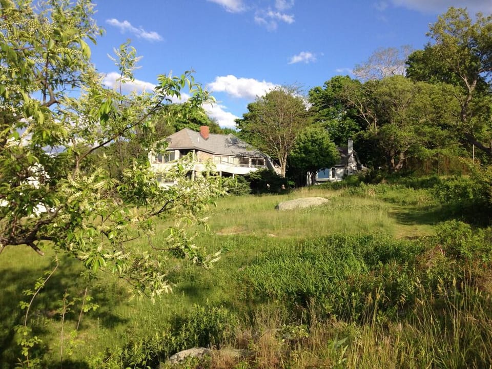 The cottage is at right; tennis courts are just visible at far right.