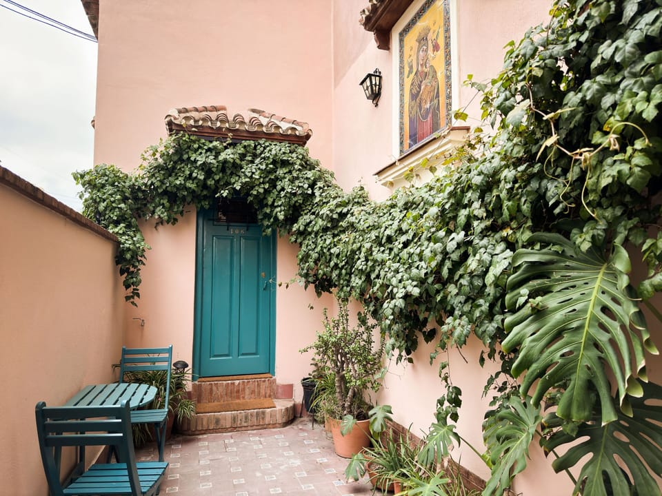 A closer view of the picturesque exterior with a quaint, greenery-framed entrance, setting the tone for a peaceful and private escape.