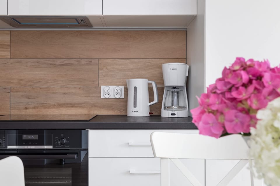 The sleek design of the kitchenette blending seamlessly with the living area.