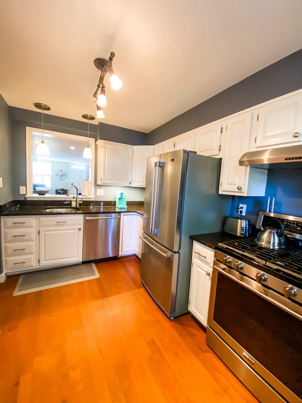 Fully equipped kitchen with gas stove, ice maker, microwave, and coffee maker. 
