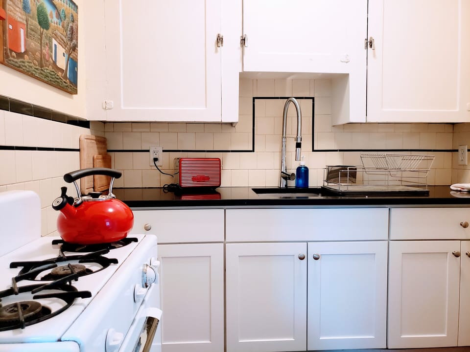 Kitchen is cozy and fully equipped.  High cabinets add spacious storage.  